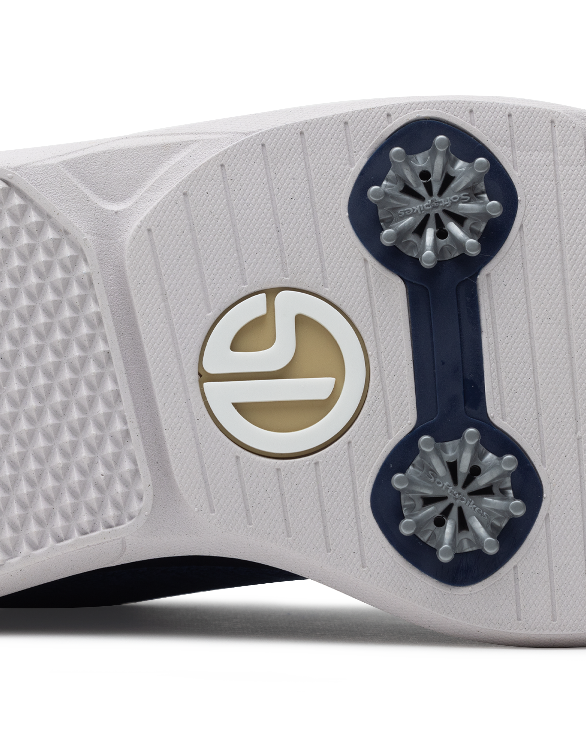 Men's Challenger Shoe in Indigo, close-up outsole view featuring a white rubber outsole with navy spike cleats and a gold and white branded logo badge detail