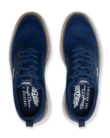 Men's Challenger Shoe in Indigo, top down view featuring a navy knit upper with navy laces, tan welt stitch detail, and a branded insole