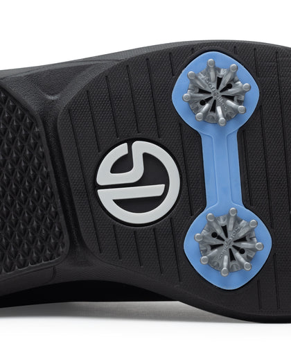 Men's Derby Shoe in Black, close-up bottom view featuring a black rubber outsole with light blue spike mounts, silver replaceable cleats, and a centered black and white Straight Down logo badge