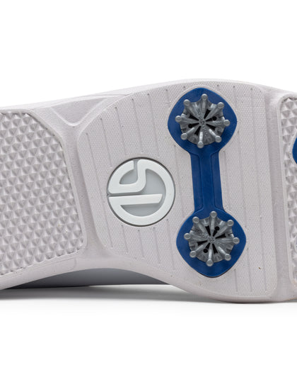 Men's Derby Shoe in White, close-up bottom view featuring a white rubber outsole with royal blue spike mounts, silver replaceable cleats, and a centered white Straight Down logo badge