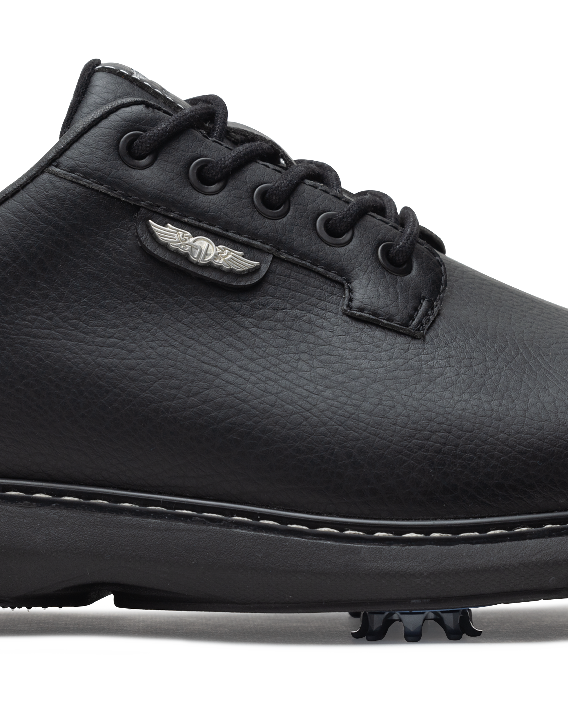 Men's Derby Shoe in Black, close-up side view featuring black pebbled leather upper with silver winged Straight Down logo badge on tongue tab, black lacing system, contrast stitch midsole trim, and spiked outsole