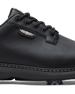 Men's Derby Shoe in Black, close-up side view featuring black pebbled leather upper with silver winged Straight Down logo badge on tongue tab, black lacing system, contrast stitch midsole trim, and spiked outsole