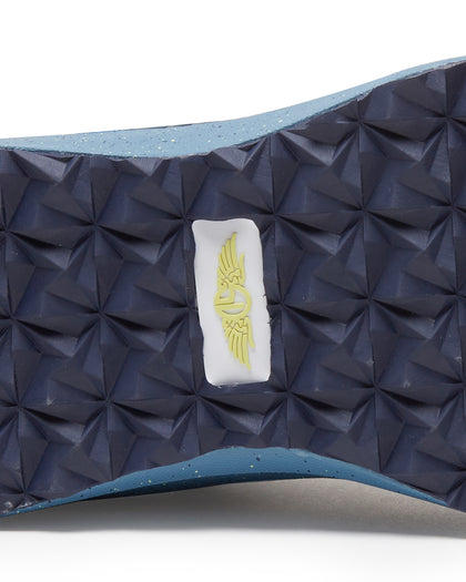 Men's Moonlight V2 Shoe in Deep Sea, close-up bottom view featuring a navy geometric pyramid-textured rubber outsole with a centered white and gold Straight Down logo badge and speckled light blue midsole edge