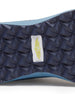Men's Moonlight V2 Shoe in Deep Sea, close-up bottom view featuring a navy geometric pyramid-textured rubber outsole with a centered white and gold Straight Down logo badge and speckled light blue midsole edge