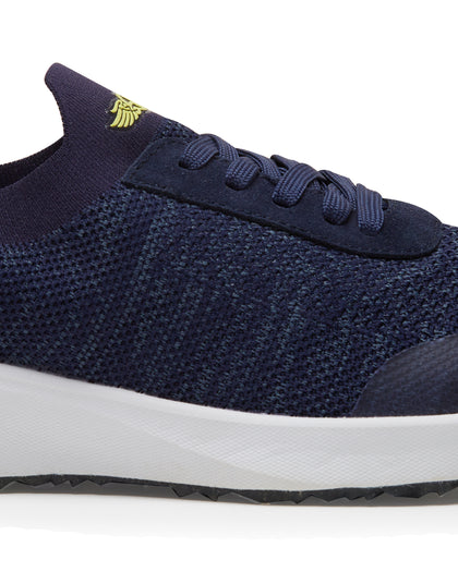 Straight Down Weekender Golf Shoe in New Indigo, close-up lateral side detail view featuring navy knit upper, yellow Straight Down wing logo on tongue, navy laces, and white midsole