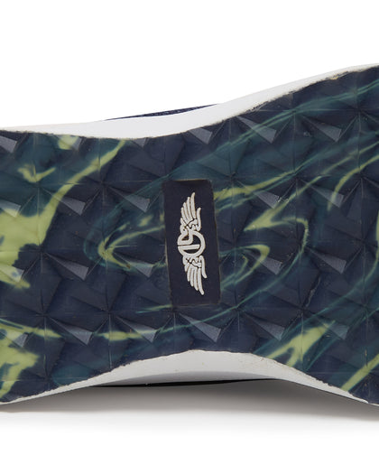 Straight Down Weekender Golf Shoe in New Indigo, close-up outsole detail view featuring navy and yellow marbled geometric pyramid traction outsole with Straight Down wing logo badge at arch