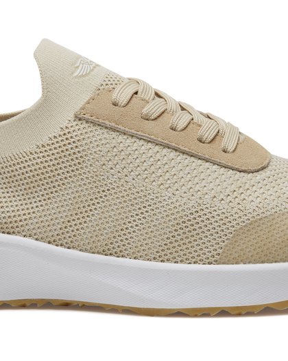 Straight Down Weekender Golf Shoe in Cashew, close-up lateral side detail view featuring cream knit upper, tan suede lace overlay, tan laces, Straight Down wing logo on knit tongue, and white midsole