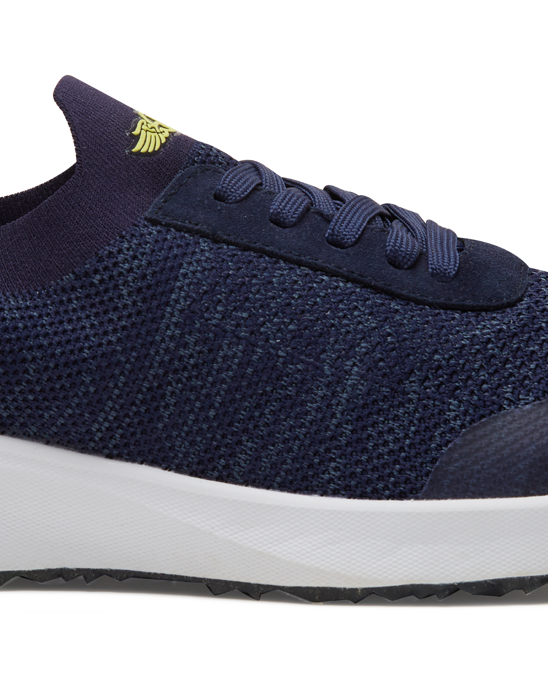 Straight Down Weekender Golf Shoe in New Indigo, close-up lateral side detail view featuring navy knit upper, yellow Straight Down wing logo on tongue, navy laces, and white midsole