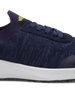 Straight Down Weekender Golf Shoe in New Indigo, close-up lateral side detail view featuring navy knit upper, yellow Straight Down wing logo on tongue, navy laces, and white midsole