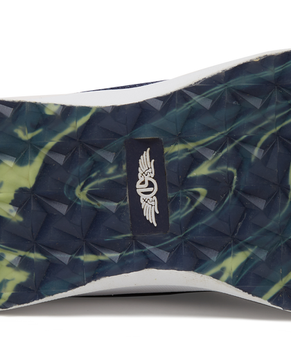 Straight Down Weekender Golf Shoe in New Indigo, close-up outsole detail view featuring navy and yellow marbled geometric pyramid traction outsole with Straight Down wing logo badge at arch