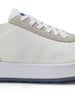 Men's Rally Shoe in White, detail close-up view featuring the white knit upper texture, light gray suede overlay at the toe box, white lace-up closure, and white midsole with navy outsole visible at the base