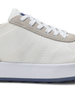 Men's Rally Shoe in White, detail close-up view featuring the white knit upper texture, light gray suede overlay at the toe box, white lace-up closure, and white midsole with navy outsole visible at the base
