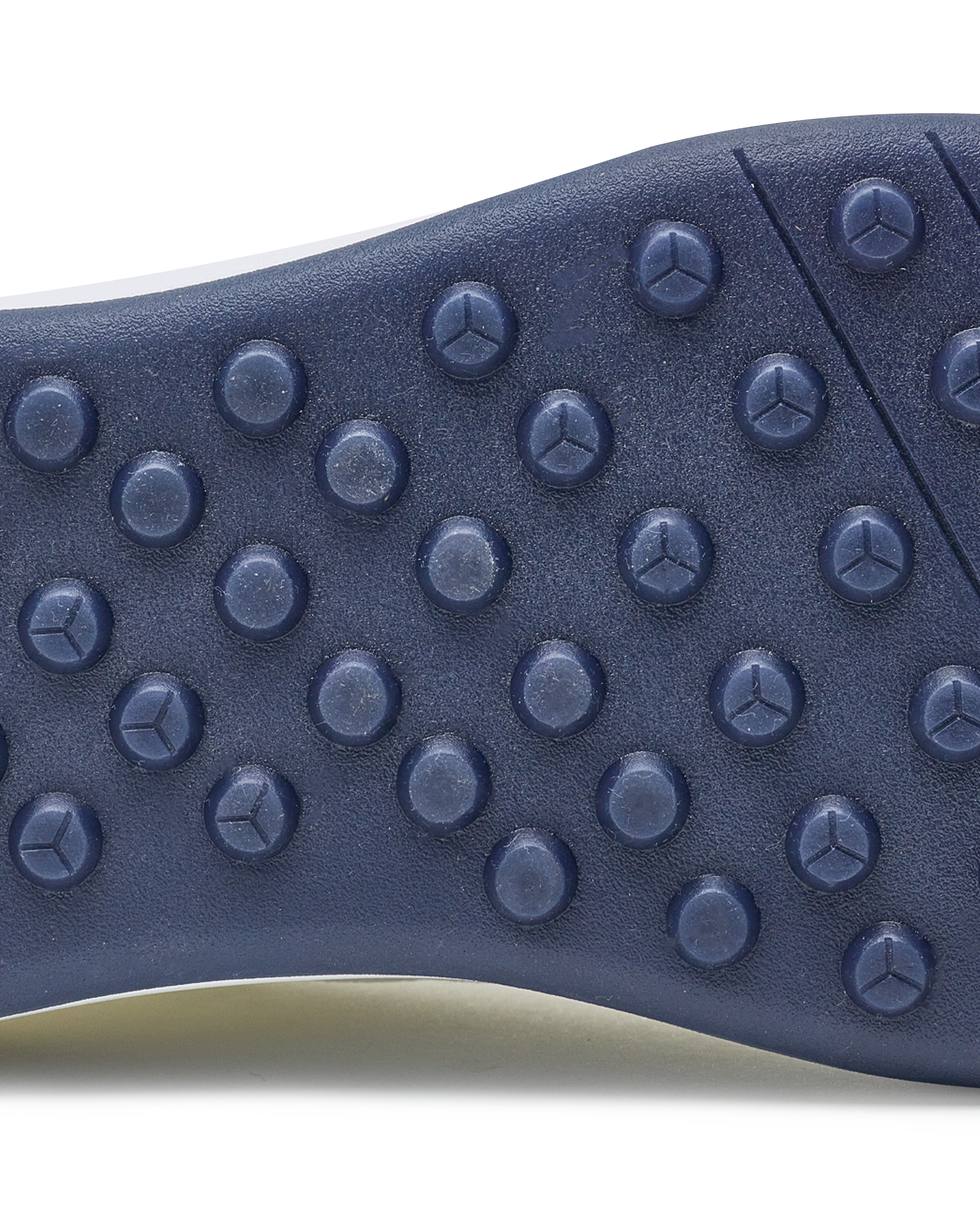 Men's Rally Shoe in White, detail close-up view of the outsole featuring navy rubber studs and flex grooves for traction and grip