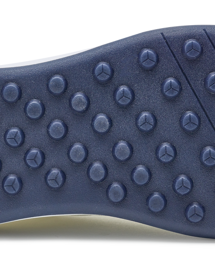 Men's Rally Shoe in White, detail close-up view of the outsole featuring navy rubber studs and flex grooves for traction and grip