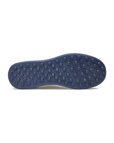 Men's Rally Shoe in White, bottom view featuring a navy rubber outsole with multi-directional traction rubber studs and flex grooves