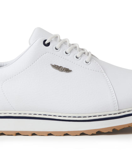 Straight Down Bourbon Hybrid Golf Shoe in White, close-up lateral side detail view featuring white pebbled leather upper, silver Straight Down wing logo badge, navy lace eyelet accents, white laces, white midsole with navy stripe accent, and gum traction outsole