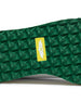 Straight Down Bourbon Hybrid Golf Shoe in White Verde, close-up outsole detail view featuring green geometric pyramid traction outsole with yellow Straight Down wing logo badge at arch