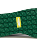 Straight Down Bourbon Hybrid Golf Shoe in White Verde, close-up outsole detail view featuring green geometric pyramid traction outsole with yellow Straight Down wing logo badge at arch
