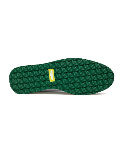Straight Down Bourbon Hybrid Golf Shoe in White Verde, bottom sole view featuring green geometric pyramid traction outsole with yellow Straight Down wing logo badge at arch