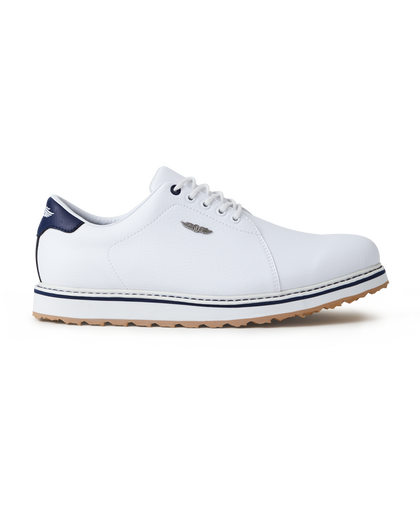 Straight Down Bourbon Hybrid Golf Shoe in White, lateral side profile view featuring white pebbled leather upper, navy heel counter, navy lace eyelet accents, silver Straight Down wing logo badge, white laces, white midsole with navy stripe accent, and gum traction outsole