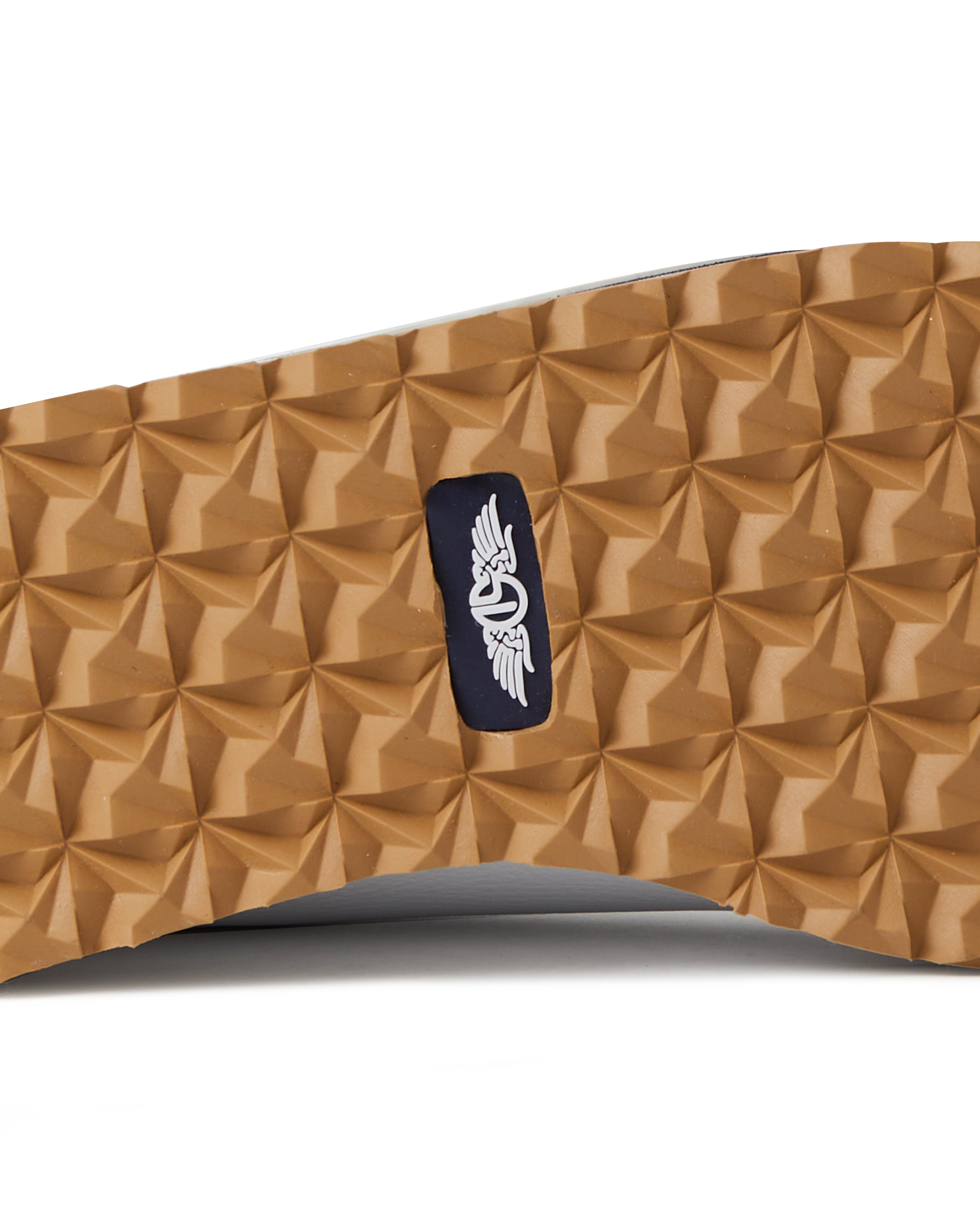Straight Down Bourbon Hybrid Golf Shoe in White, close-up outsole detail view featuring gum rubber geometric pyramid traction outsole with navy Straight Down wing logo badge at arch