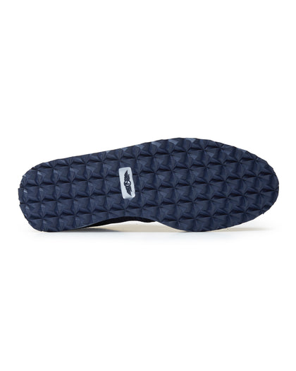 Straight Down Harbour Knit Hybrid Golf Shoe in New Indigo, bottom sole view featuring navy geometric pyramid traction outsole with Straight Down wing logo badge at arch