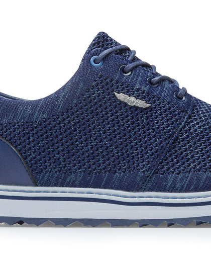 Straight Down Harbour Knit Hybrid Golf Shoe in New Indigo, close-up lateral side detail view featuring navy knit upper, silver Straight Down wing logo badge, navy laces, and white midsole with navy stripe accent