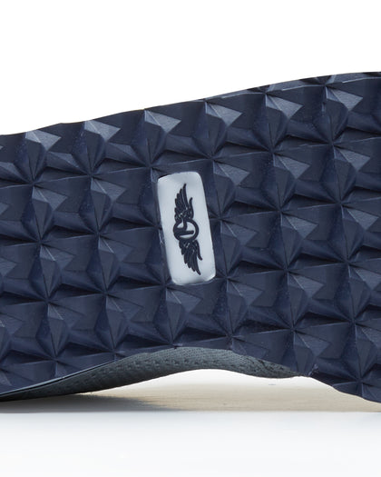 Straight Down Harbour Knit Hybrid Golf Shoe in Silver, close-up outsole detail view featuring navy geometric pyramid traction outsole with Straight Down wing logo badge at arch