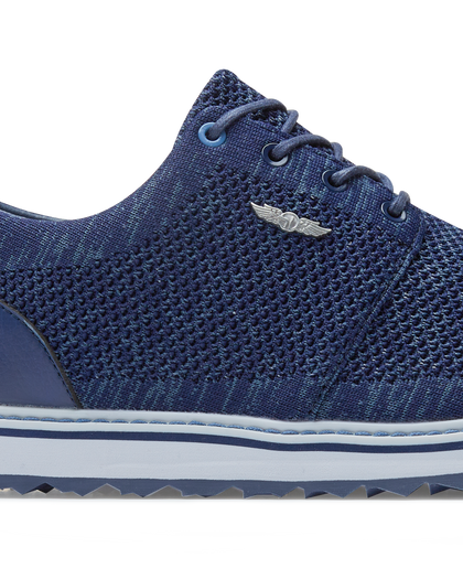 Straight Down Harbour Knit Hybrid Golf Shoe in New Indigo, close-up lateral side detail view featuring navy knit upper, silver Straight Down wing logo badge, navy laces, and white midsole with navy stripe accent