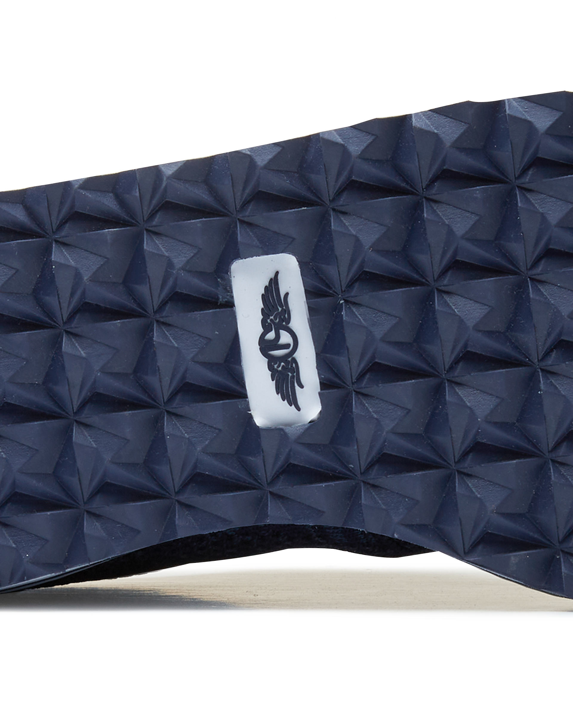 Straight Down Harbour Knit Hybrid Golf Shoe in New Indigo, close-up outsole detail view featuring navy geometric pyramid traction outsole with Straight Down wing logo badge at arch
