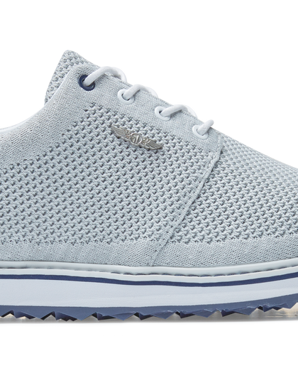 Straight Down Harbour Knit Hybrid Golf Shoe in Silver, close-up lateral side detail view featuring light gray knit upper, silver Straight Down wing logo badge, white laces, and navy stripe midsole accent