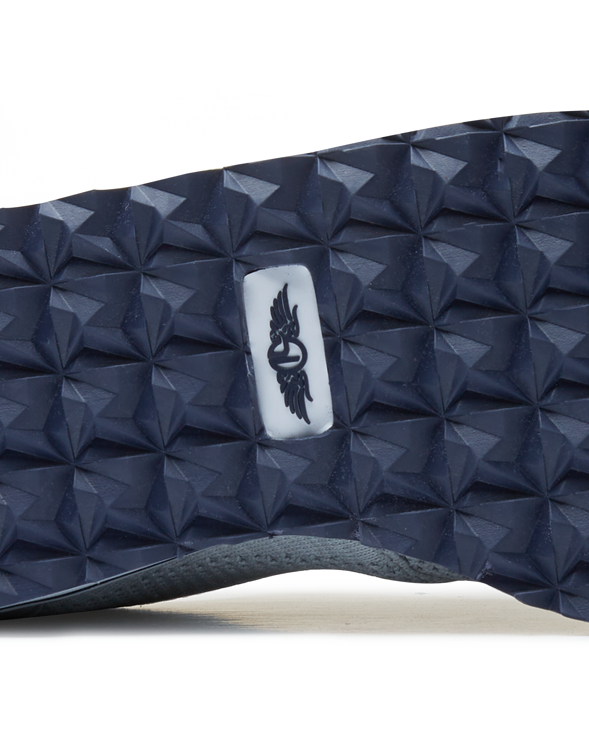 Straight Down Harbour Knit Hybrid Golf Shoe in Silver, close-up outsole detail view featuring navy geometric pyramid traction outsole with Straight Down wing logo badge at arch