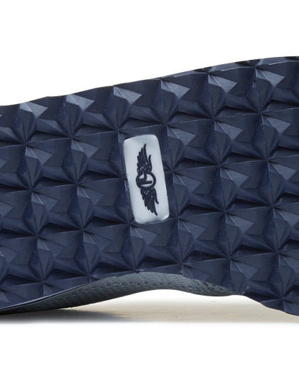 Straight Down Harbour Knit Hybrid Golf Shoe in Silver, close-up outsole detail view featuring navy geometric pyramid traction outsole with Straight Down wing logo badge at arch