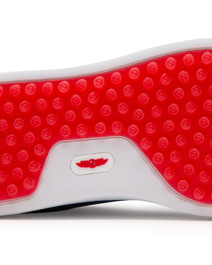 Straight Down Boardwalk Golf Shoe in Federal, close-up outsole detail view featuring solid red circular traction nub outsole with white arch bridge and red Straight Down wing logo badge at center
