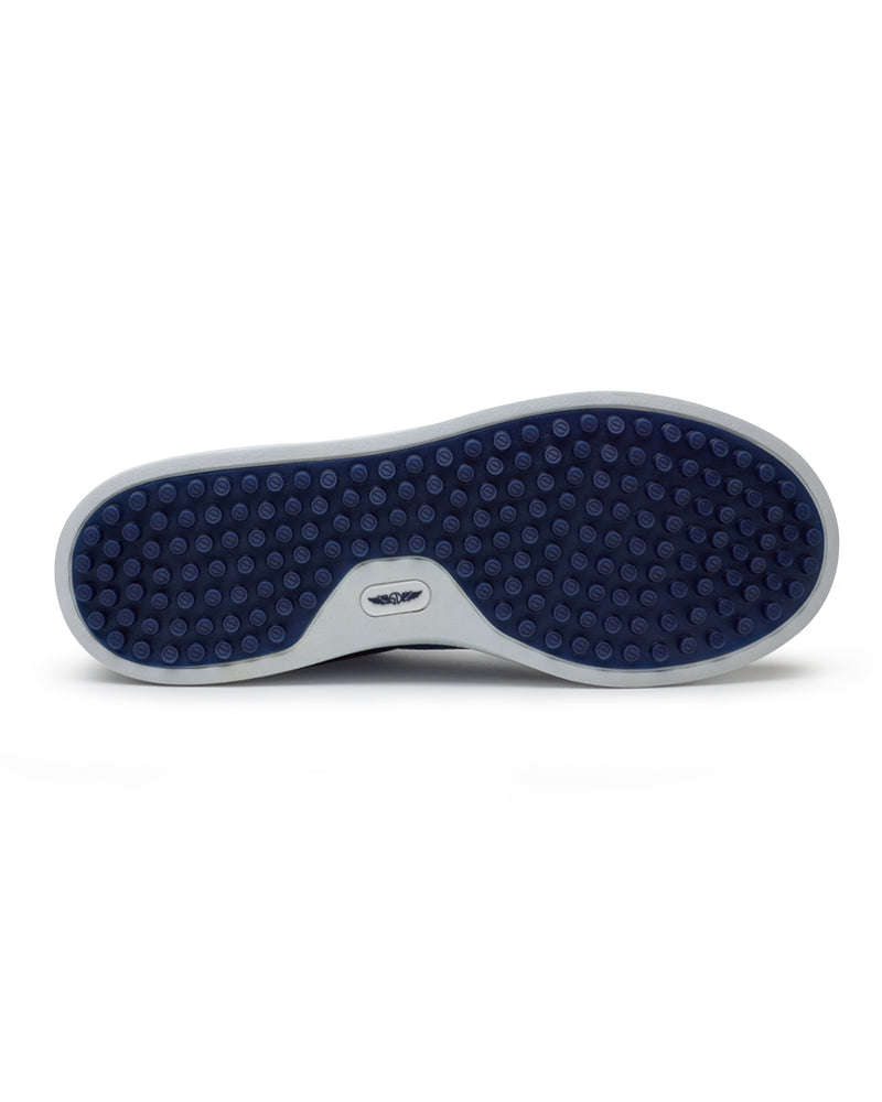 Straight Down Boardwalk Golf Shoe in Petrol, bottom sole view featuring solid navy circular traction nub outsole with white arch bridge and navy Straight Down wing logo badge at center