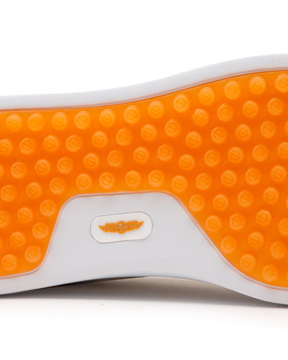 Straight Down Boardwalk Golf Shoe in Stone, close-up outsole detail view featuring solid orange circular traction nub outsole with white arch bridge and orange Straight Down wing logo badge at center