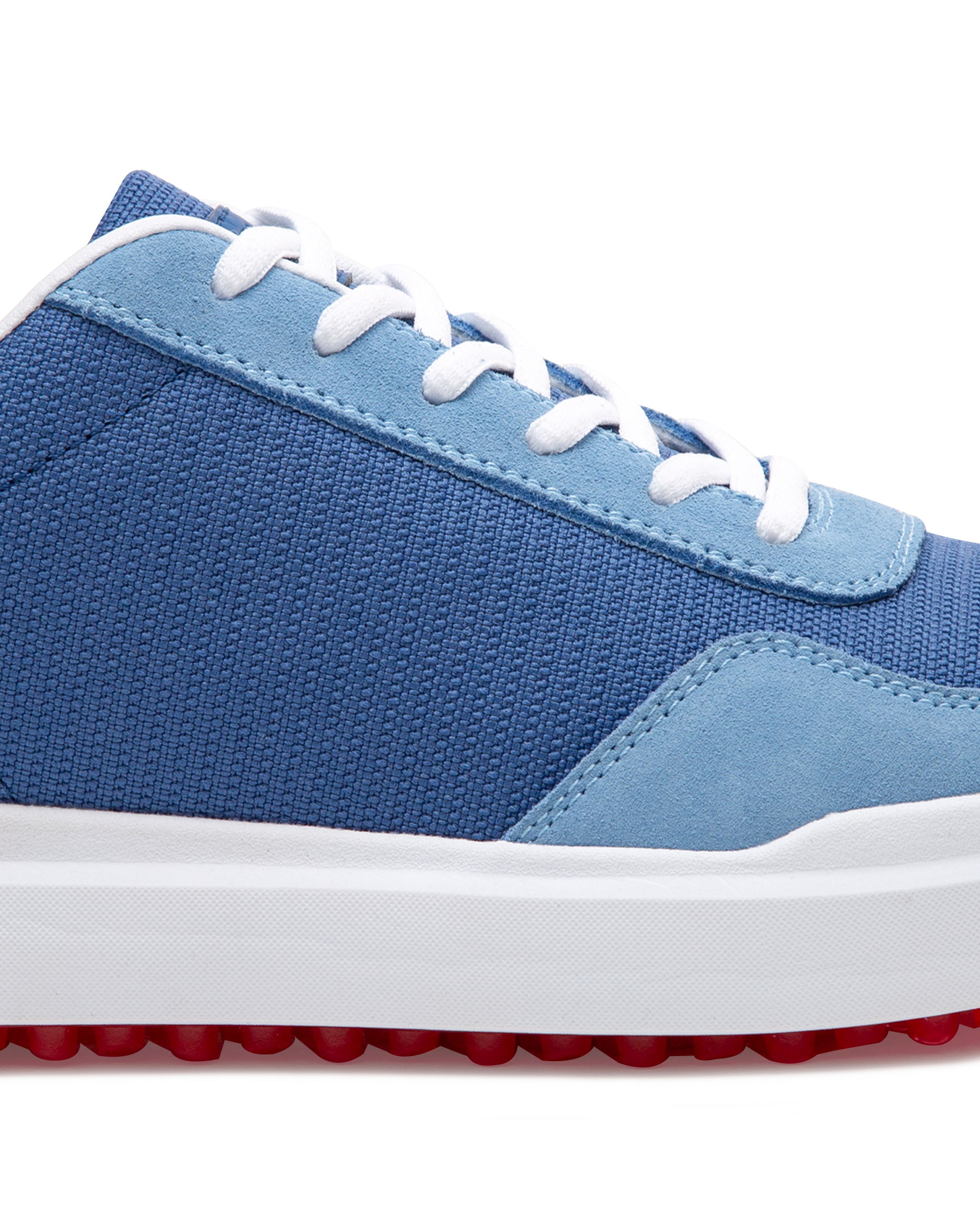 Straight Down Boardwalk Golf Shoe in Federal, close-up lateral side detail view featuring medium blue canvas upper, light blue suede lace overlay and heel panel, white laces, and red traction outsole