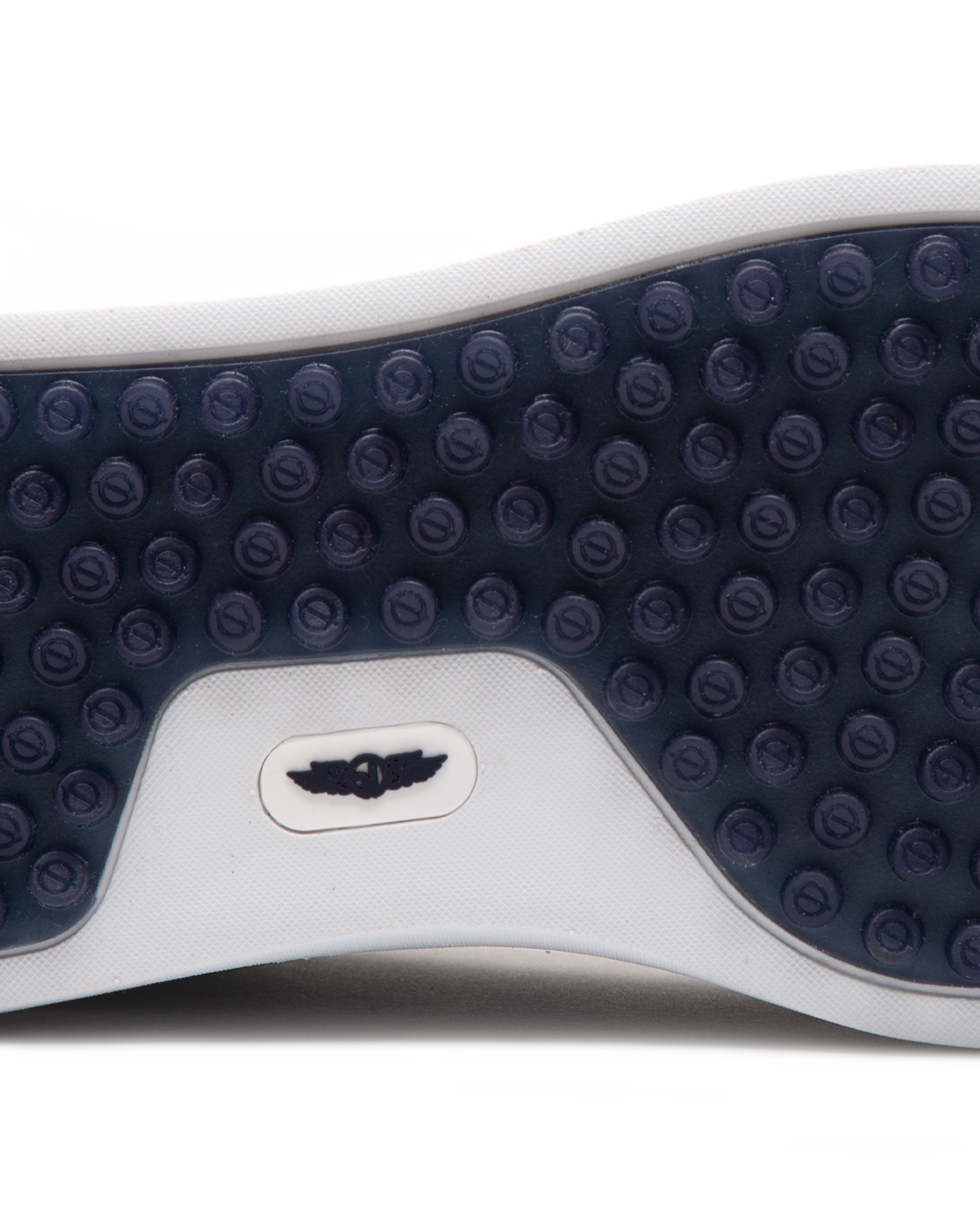 Straight Down Boardwalk Golf Shoe in Petrol, close-up outsole detail view featuring solid navy circular traction nub outsole with white arch bridge and navy Straight Down wing logo badge at center