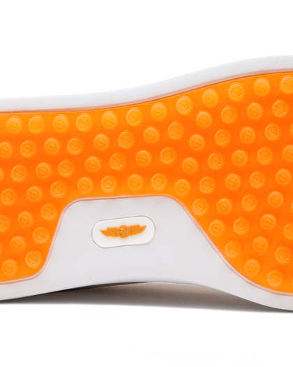 Straight Down Boardwalk Golf Shoe in Stone, close-up outsole detail view featuring solid orange circular traction nub outsole with white arch bridge and orange Straight Down wing logo badge at center