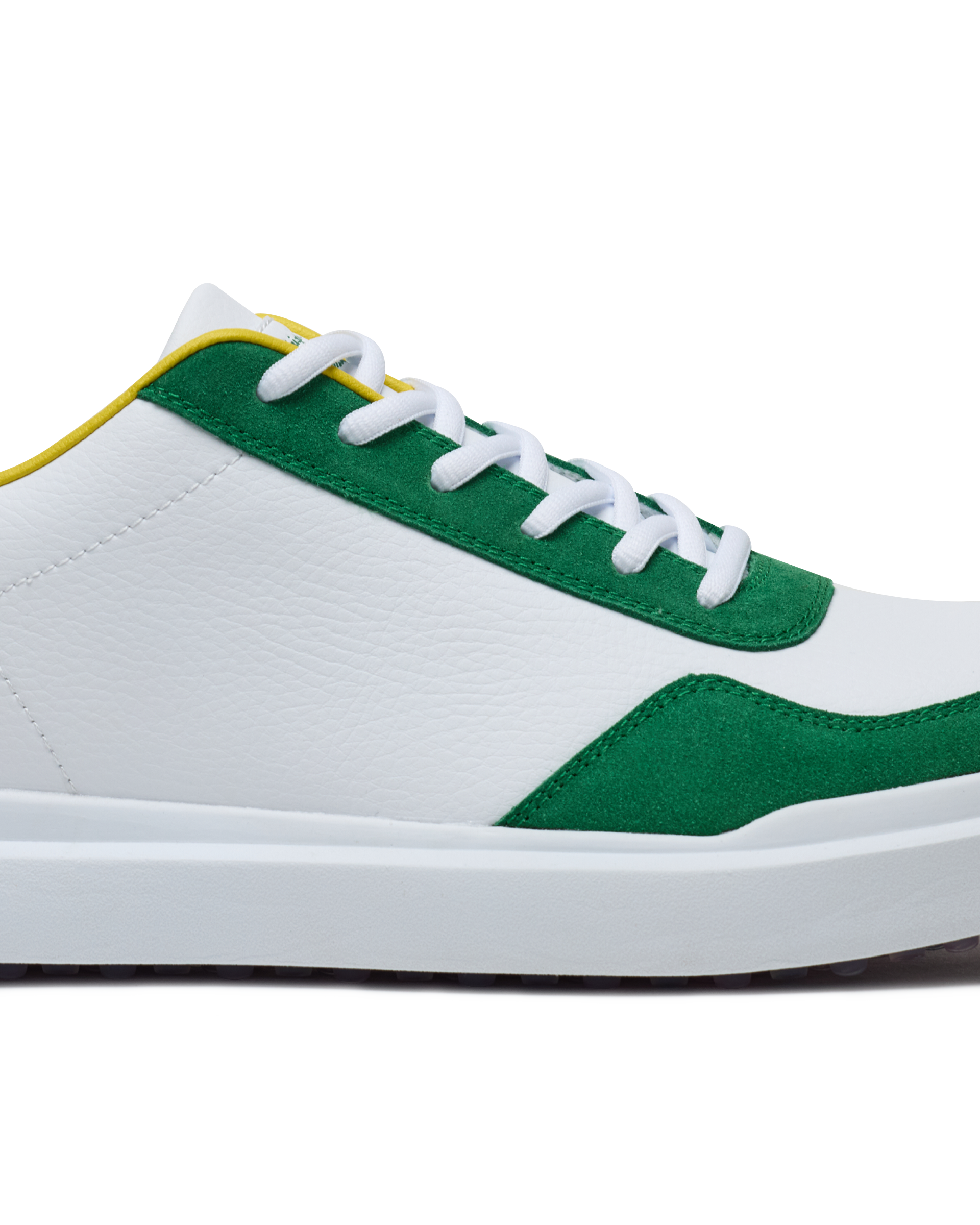 Straight Down Boardwalk Golf Shoe in Verde, close-up lateral side detail view featuring white pebbled leather upper, green suede toe box and heel overlay, yellow collar trim, and white laces