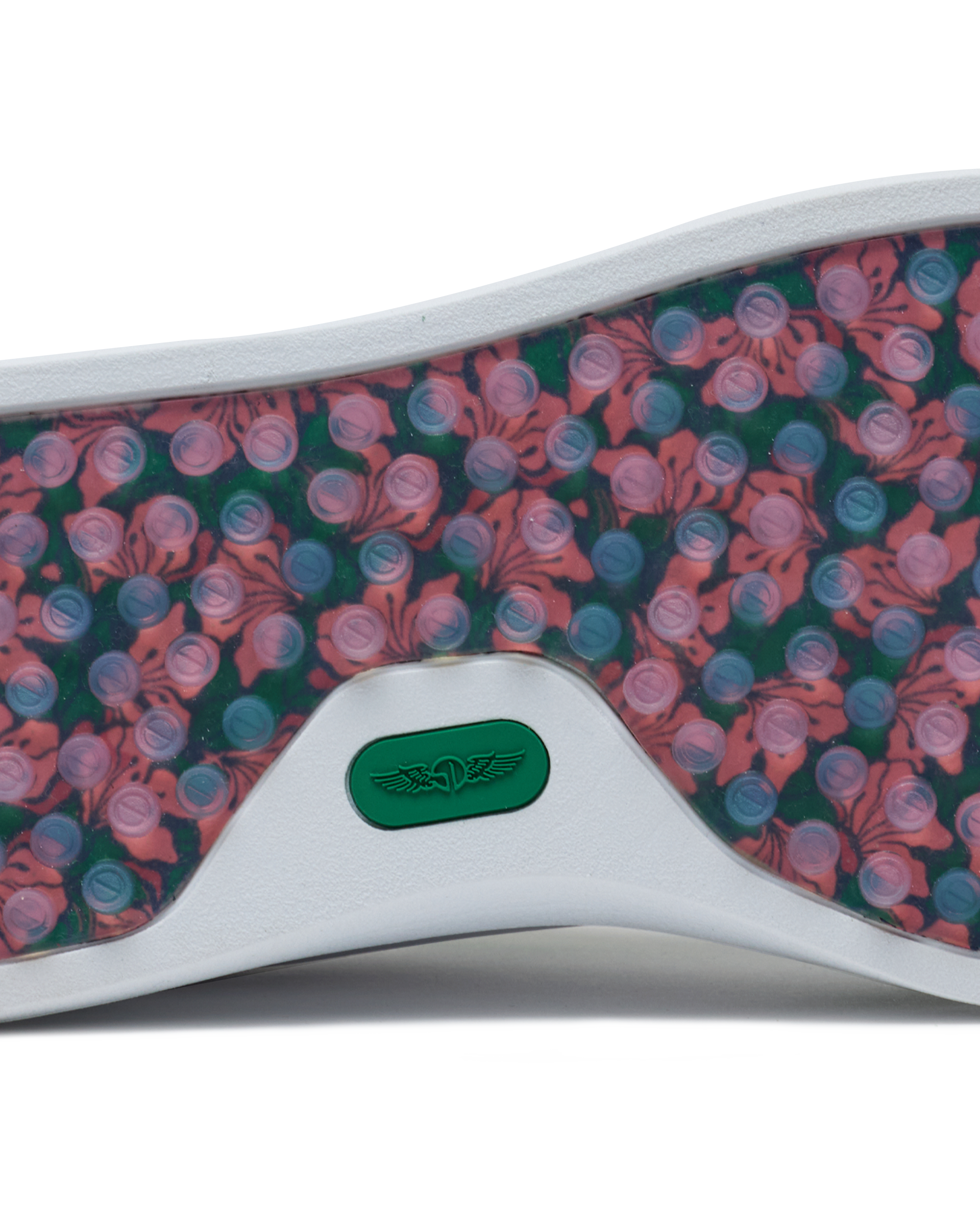 Straight Down Boardwalk Golf Shoe in Verde, close-up outsole detail view featuring floral hibiscus print with circular traction nubs in pink and blue tones and green Straight Down wing logo badge at arch