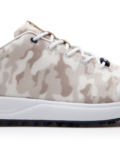 Straight Down Defender Golf Shoe in Camo Stone, close-up lateral side detail view featuring cream and tan desert camouflage print upper, navy lace eyelet accents, white laces, and navy traction outsole