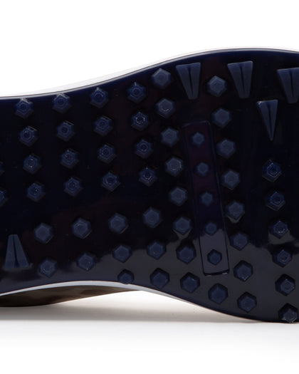 Straight Down Defender Golf Shoe in Camo Stone, close-up outsole detail view featuring navy mixed traction outsole with hexagonal and triangular lug pattern and white midsole edge