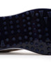 Straight Down Defender Golf Shoe in Camo Stone, close-up outsole detail view featuring navy mixed traction outsole with hexagonal and triangular lug pattern and white midsole edge