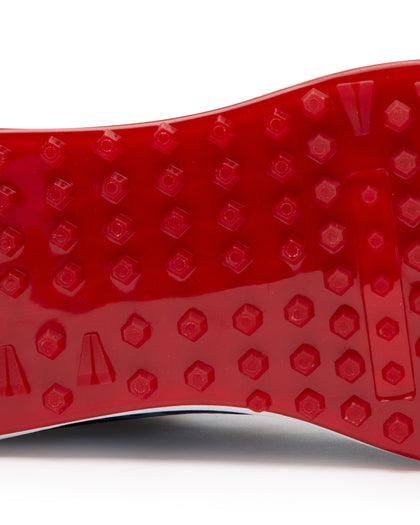 Straight Down Defender Golf Shoe in Camo Ocean, close-up outsole detail view featuring solid red mixed traction outsole with hexagonal and triangular lug pattern and white midsole edge