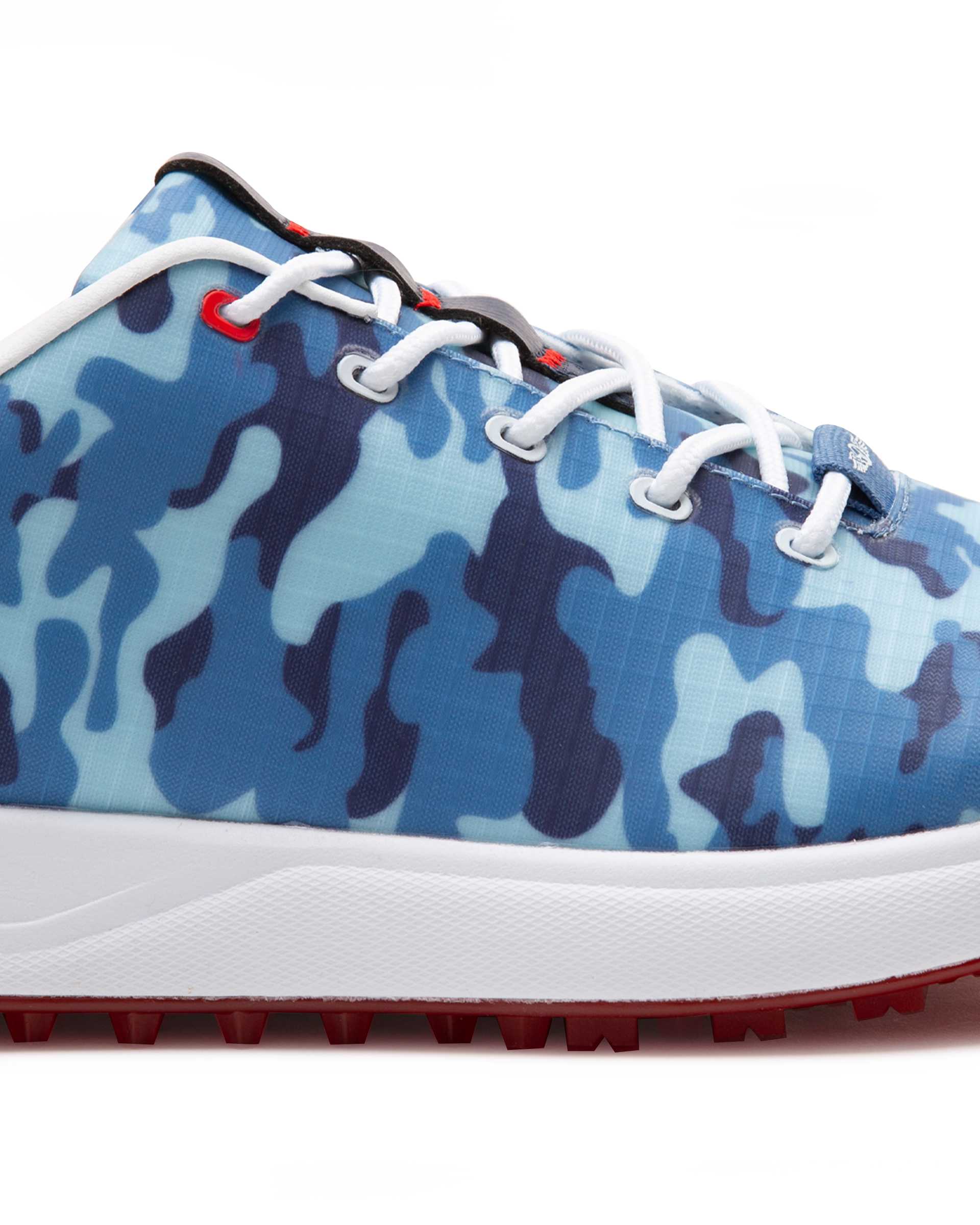 Straight Down Defender Golf Shoe in Camo Ocean, close-up lateral side detail view featuring blue tonal camouflage print upper, red lace eyelet accents, white laces, white midsole, and red traction outsole