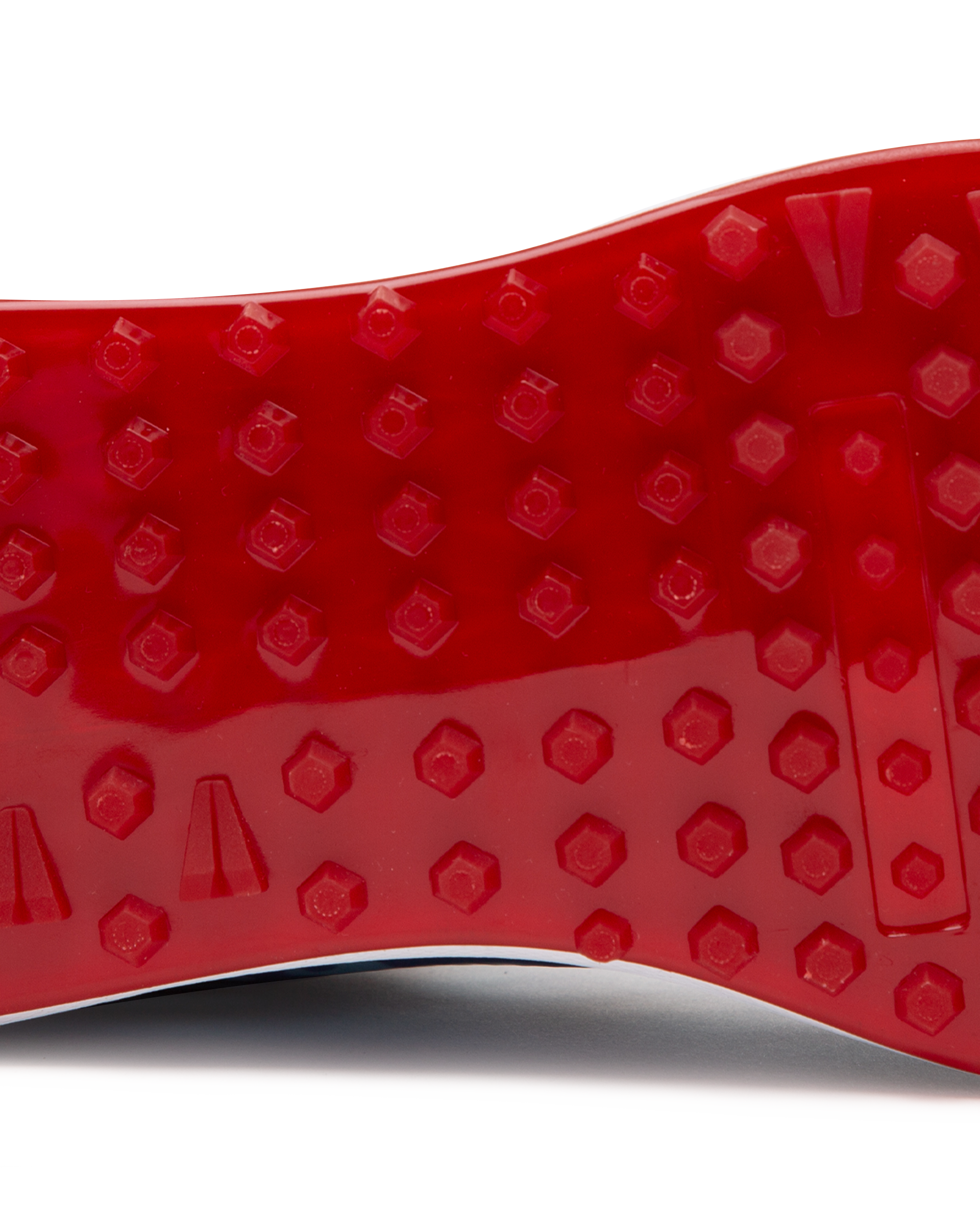 Straight Down Defender Golf Shoe in Camo Ocean, close-up outsole detail view featuring solid red mixed traction outsole with hexagonal and triangular lug pattern and white midsole edge
