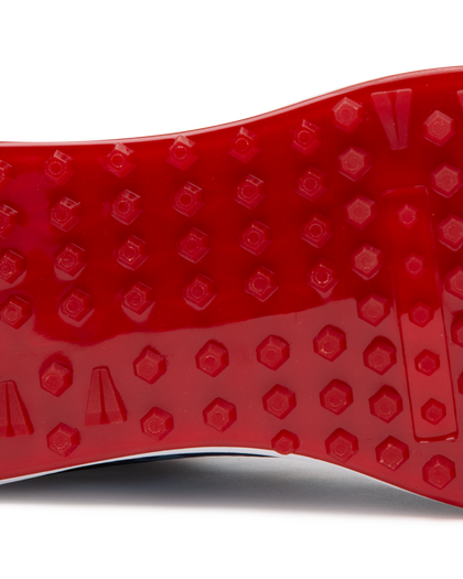 Straight Down Defender Golf Shoe in Camo Ocean, close-up outsole detail view featuring solid red mixed traction outsole with hexagonal and triangular lug pattern and white midsole edge