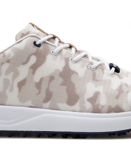Straight Down Defender Golf Shoe in Camo Stone, close-up lateral side detail view featuring cream and tan desert camouflage print upper, navy lace eyelet accents, white laces, and navy traction outsole
