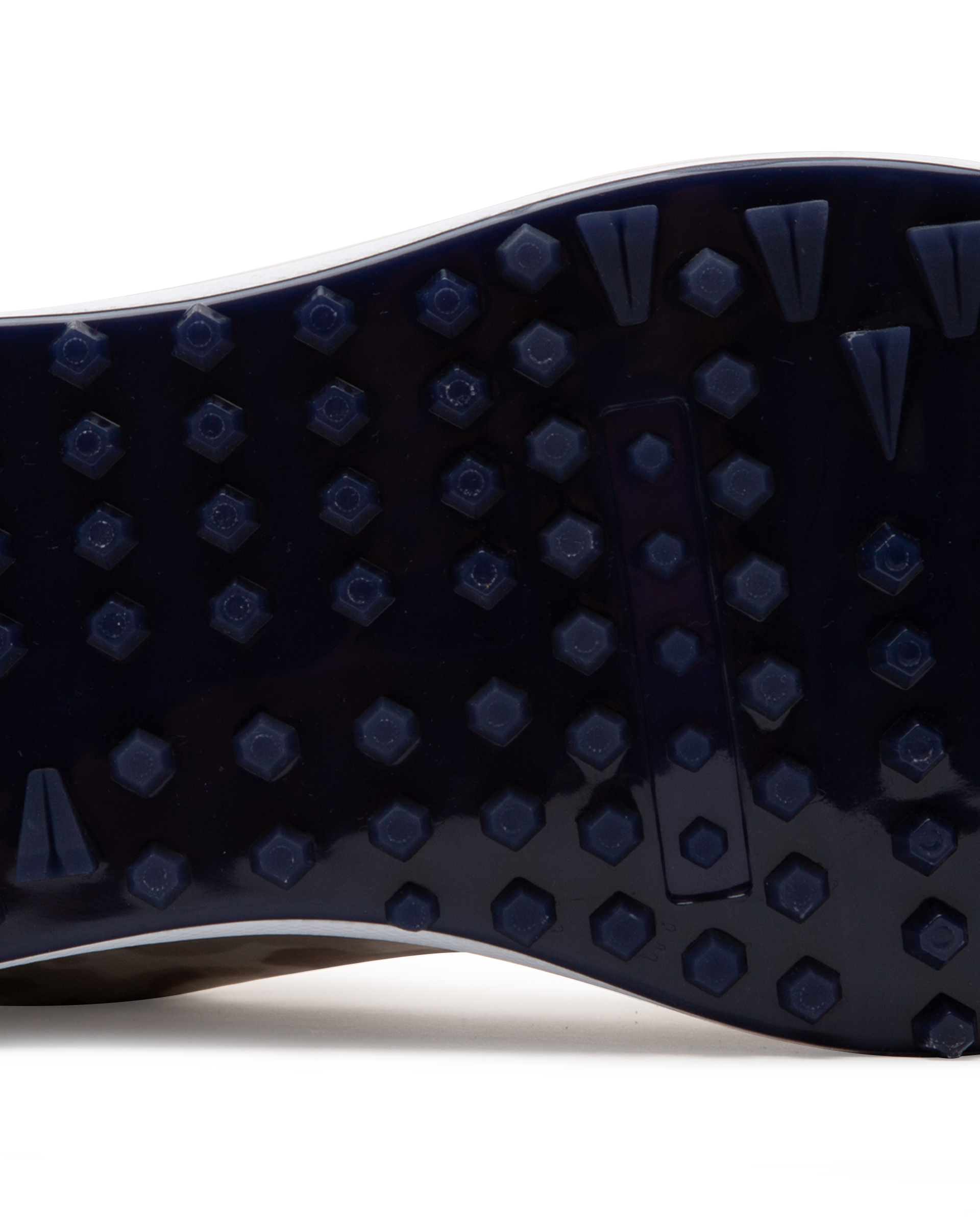 Straight Down Defender Golf Shoe in Camo Stone, close-up outsole detail view featuring navy mixed traction outsole with hexagonal and triangular lug pattern and white midsole edge